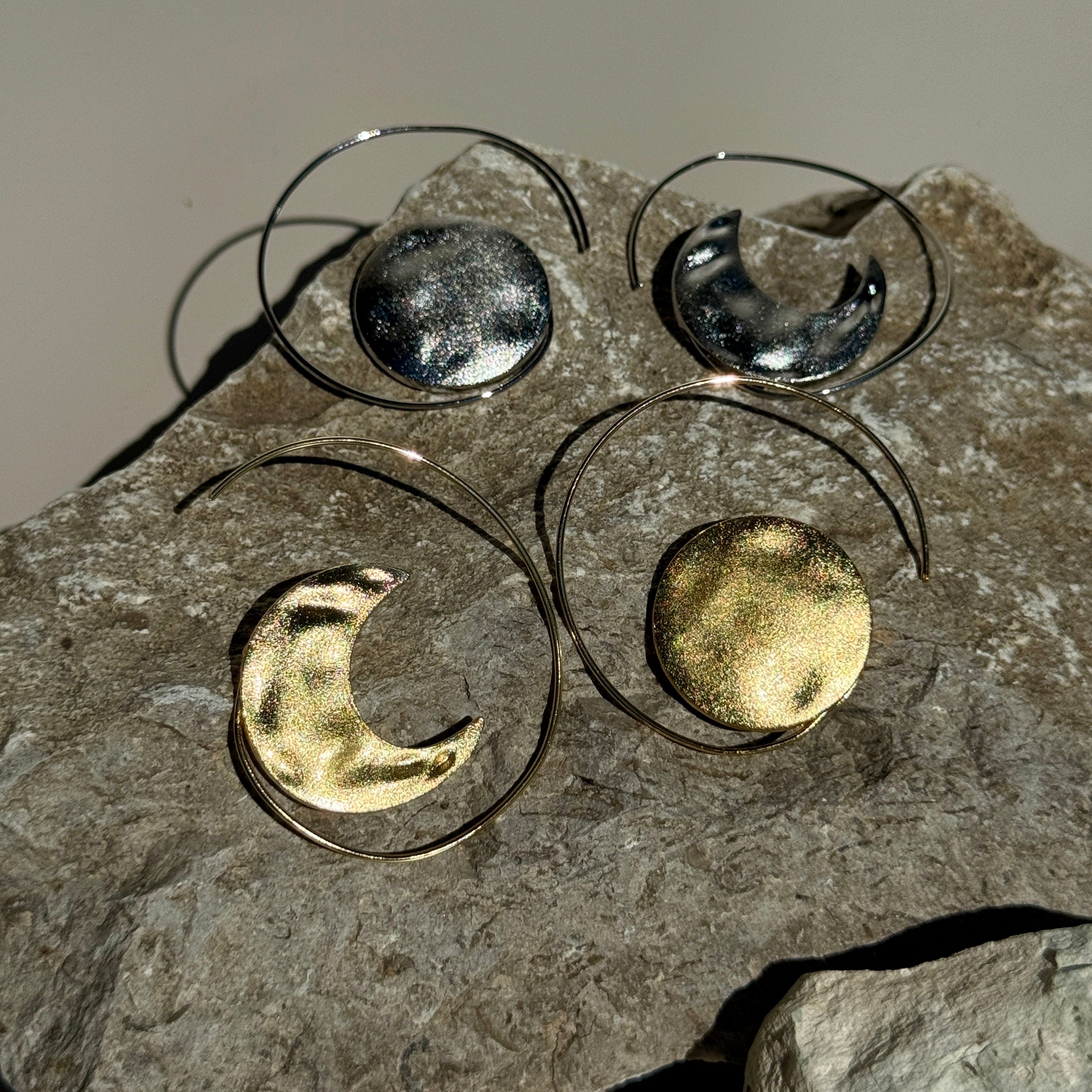 Metallic moon phases on a stone surface